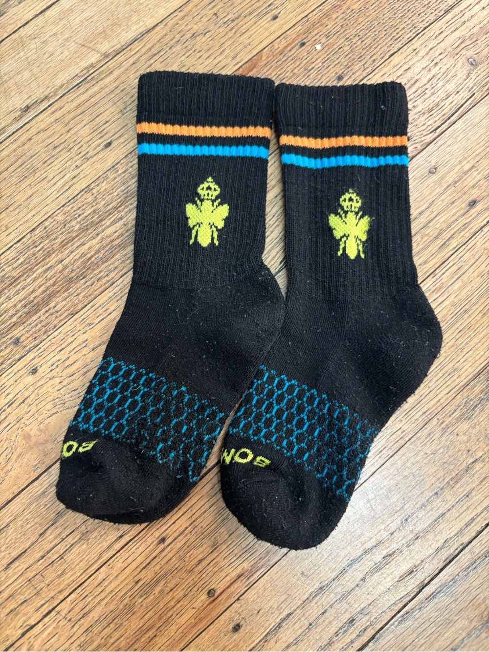 Bombas Black Kids Crew Socks with Neon Green Bee and Blue/Orange Stripes
